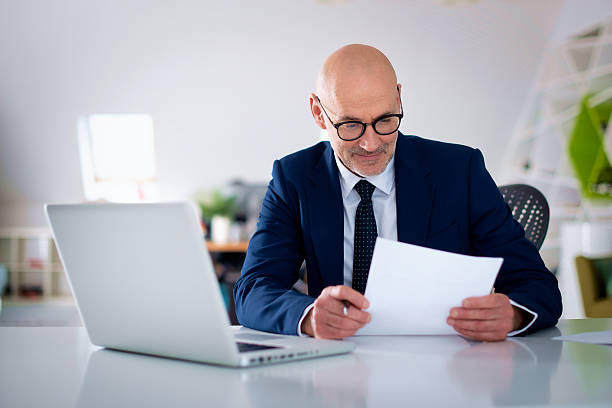 istock Caucasian man with laptop sitting at office desk and working 2233539315