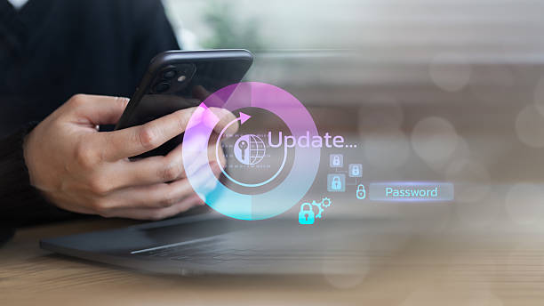 istock Close-up of a man using a smartphone with a hologram showing system update, password protection, and cybersecurity. Concept of secure digital technology, mobile authentication, and IT security 2233540088