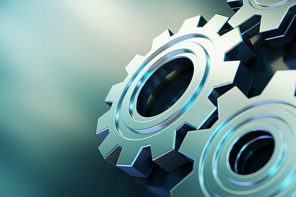 Metal gears interlocked, showcasing mechanical and engineering precision, symbolising teamwork, innovation, and industrial processes. The composition highlights machinery, mechanics, and industrial technology in a detailed macro view.