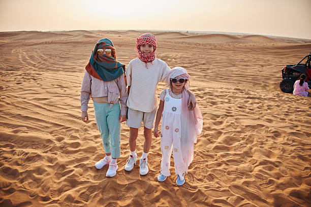 istock Beautiful children in Dubai desert 2233540927