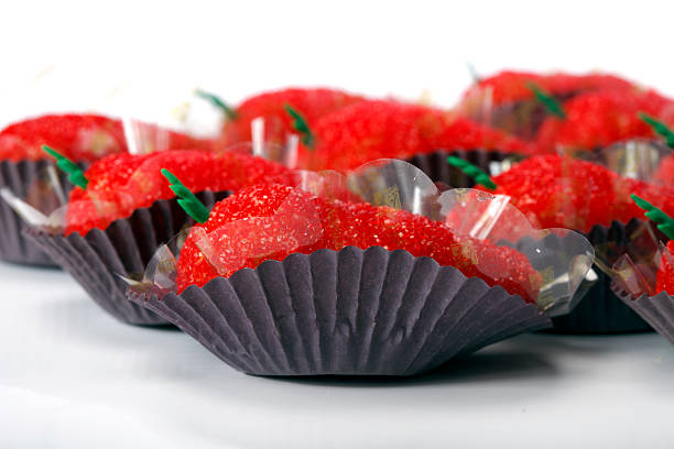 Assorted brigadeiros, traditional brazilian sweets, presented in rows on a wooden surface