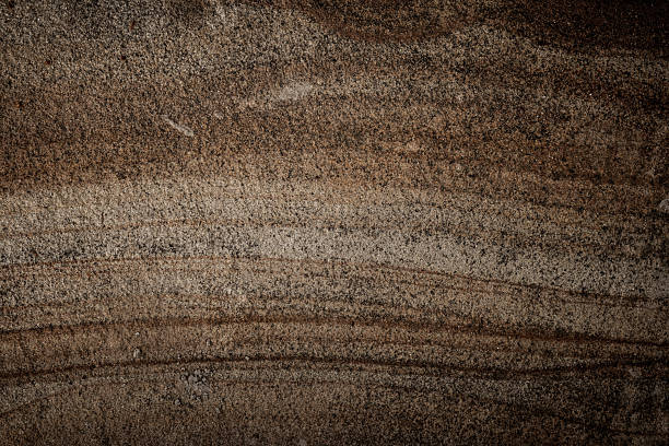Natural stone texture featuring earthy brown shades with intricate patterns, suitable for backgrounds or design inspiration.