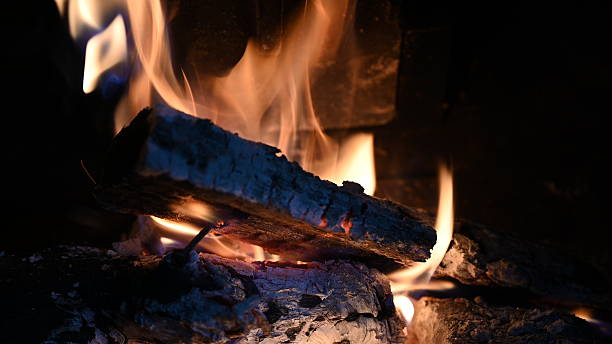 istock Burning Firewood in Fireplace with Glowing Flames 2233541642