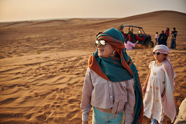 Beautiful girls in Dubai desert. Vacation mood.