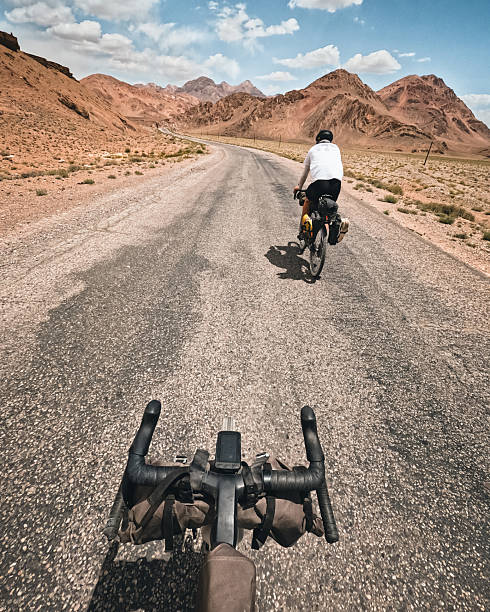 Personal perspective from young man to friend, bicycling on remote rural road. Bikepacking Pamir Highway