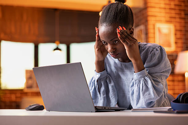 istock Stressed entrepreneur massaging head and looking at laptop 2233545633