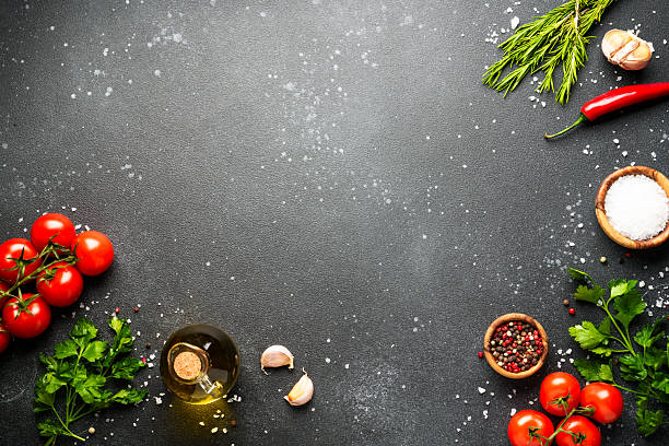 istock Food background with fresh vegetables, herbs and spices on black. 2233546862