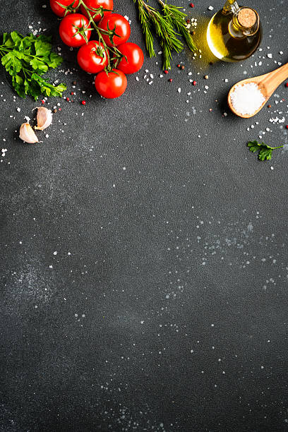 istock Food background with fresh vegetables, herbs and spices on black. 2233546870