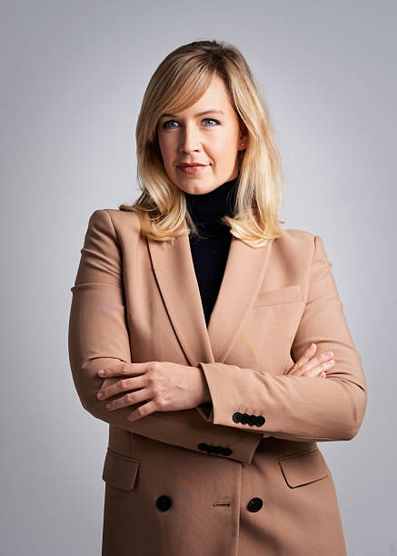 istock Blond haired woman standing against isolated background 2233547170