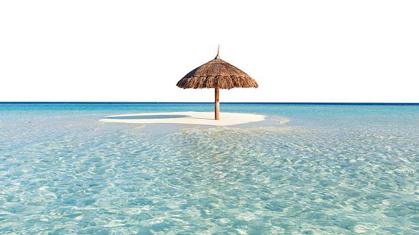 istock Thatched umbrella on small sandy island surrounded by clear ocean water. 2233547652