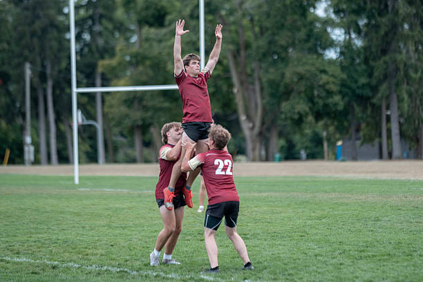 istock Team Building Exercise During Rugby Training Session on a Lush Green Field 2233549705