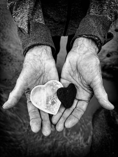 istock Black and White Stones Held in Elderly Hands Symbolizing Balance and Unity 2233551771