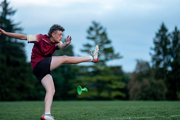 istock Athletic Male Kicking on Sport Field During Training Session in Park 2233552233