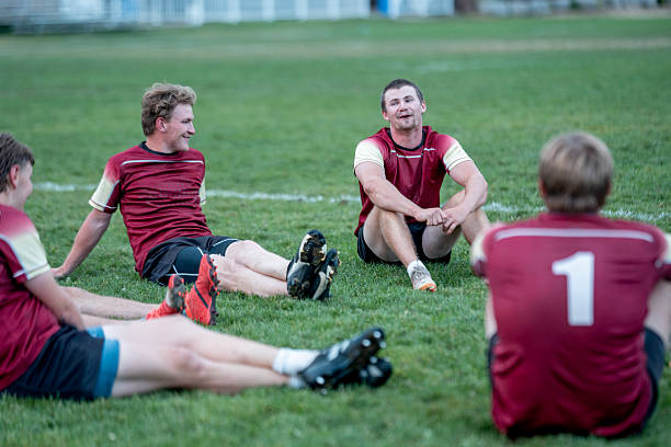 istock Young Athletes Resting and Socializing on a Soccer Field 2233552357