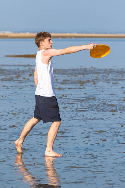 istock Teenage Boy Playing With A Frisbee 2233552807