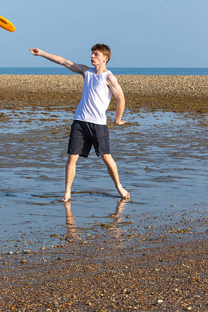 istock Teenage Boy Playing With A Frisbee 2233552969
