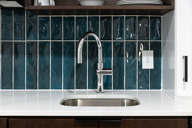 istock A kitchen faucet detail with a blue tiled backsplash. 2233554720