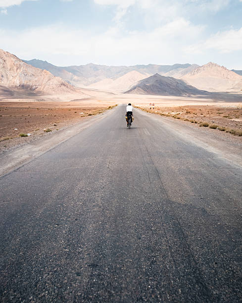 istock Bikepacker rides remote mountain roads 2233554778
