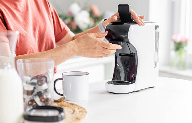 istock Woman Making Coffee In Coffeemaker 2233558847