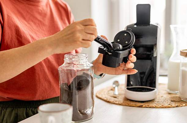 istock Woman Making Coffee In Coffee Machine 2233558918