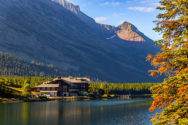 Browning, MT, USA - August 12, 2025: A serene view of the historic Many Glacier Hotel is captured from Swiftcurrent Lake in Glacier National Park