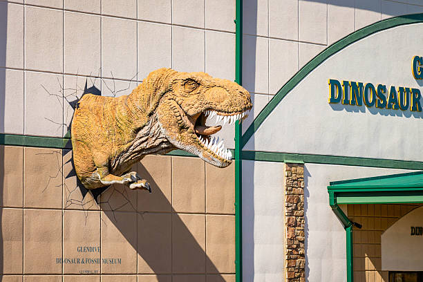 Glendive, MT, USA - July 24, 2025: The Glendive Dinosaur and Fossil Museum features a T. rex head and large dinosaur skeletons visible from its exterior
