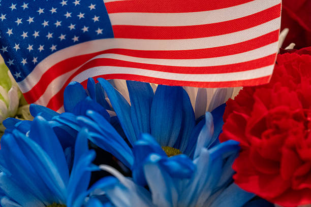 YORK, PA, USA - AUGUST 31, 2025: Close-up of a colorful bouquet of patioric theme red, white, and blue cut flowers in a bouquet with a small US Flag decoration.