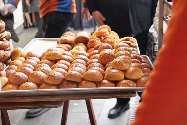 istock Freshly baked bread rolls on display at a bustling market 2233560500