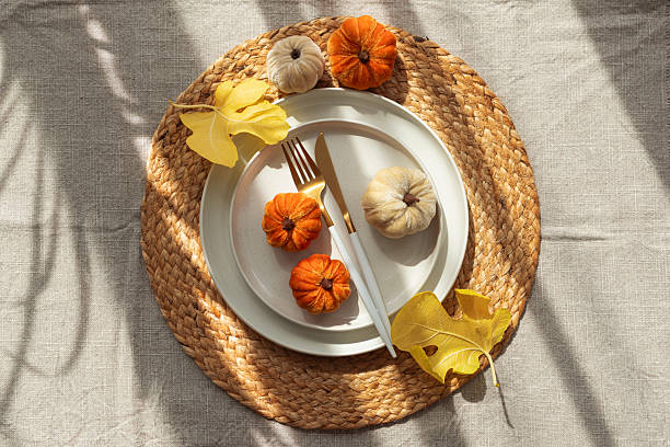 istock Autumn Table Setting with Decorative Pumpkins and Seasonal Leaves 2233571278