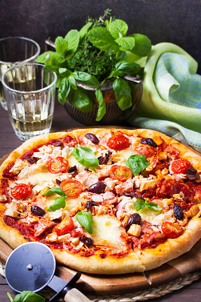 istock Delicious pizza served on wooden pizza board 2233574055