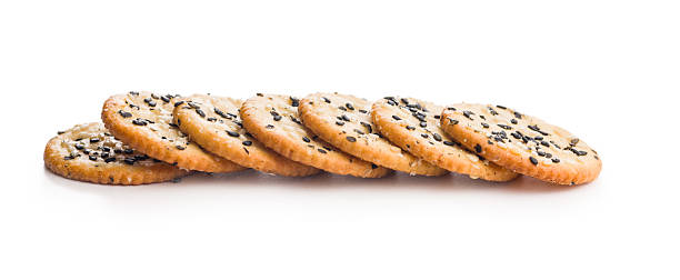 istock Crispy round salted crackers with sesame seeds isolated on white background. 2233577973