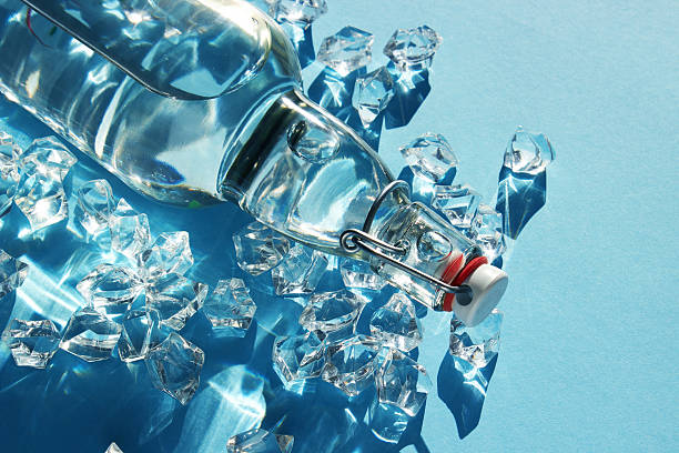 istock Bottle of water with ice on a blue 2233583088