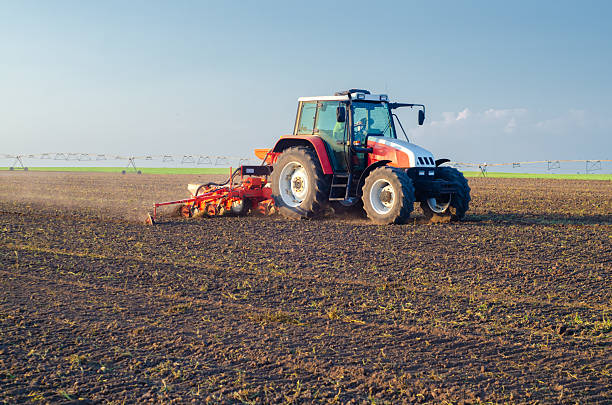 istock Tractor sowing on agricultural field in spring 2233583681