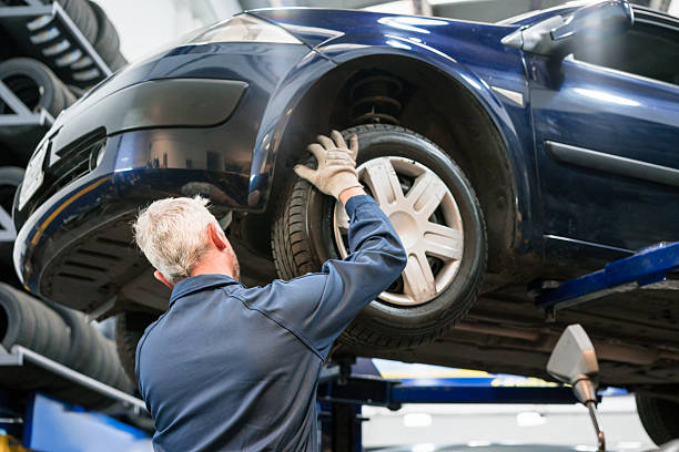 istock Car mechanic checking car wheel 2233584400