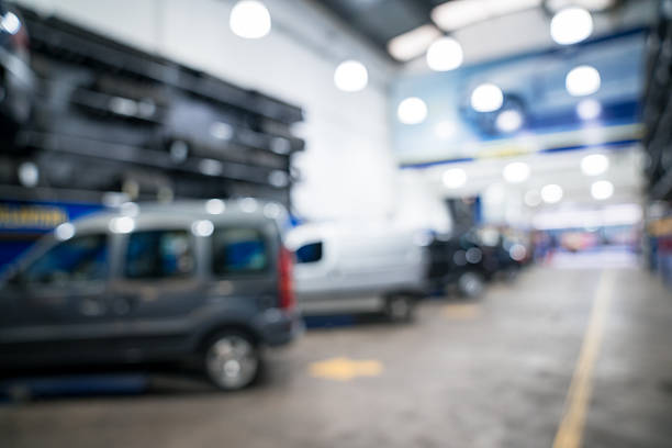 Portrait of automotive technician wave hi and open kit full of equipments. Open car hood and need to fix problem of engine. Car maintenance service concept