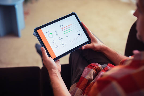 istock Business Report Viewed on Tablet Held by Relaxed Individual Indoors 2233589620
