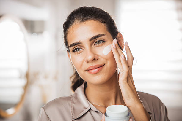 istock Young woman applying moisturizing cream 2233589970