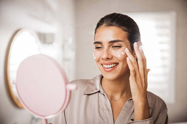 istock Young woman applying moisturizing cream 2233589973