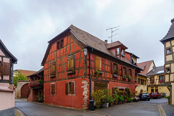 Bergheim, France - October 02, 2024: Street scene with typical houses, locals and visitors, in Bergheim, Haut-Rhin, Alsace, France