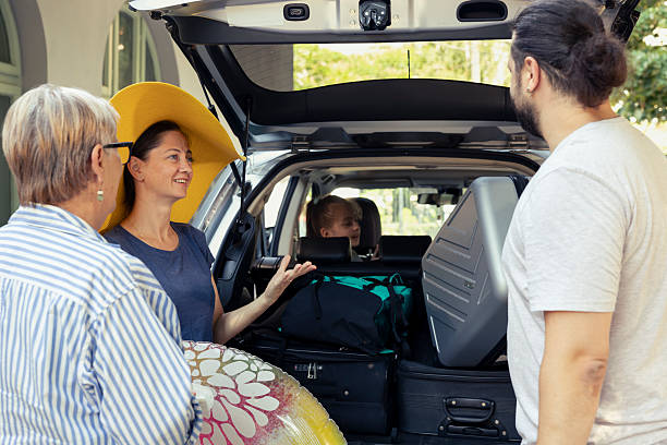 istock Large family loading the car with beach items for a fun summer holiday 2233590173