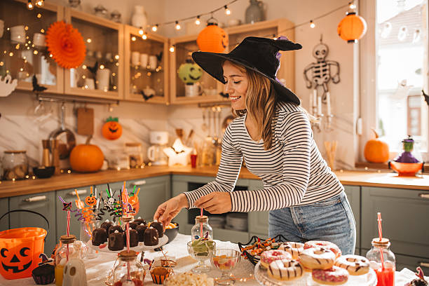 istock Woman preparing food table for Halloween 2233590182