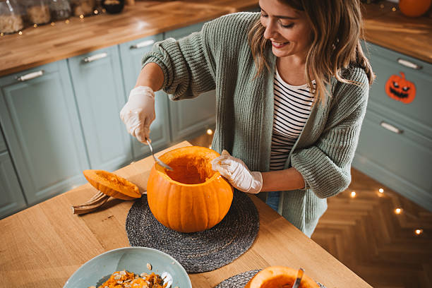 istock Woman carving pumpkin for Halloween 2233590203