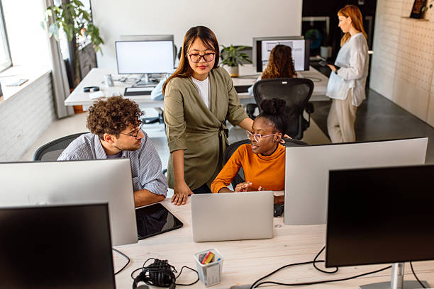 istock Multiethnic group of young colleagues working in modern office 2233592386