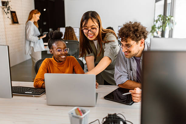 istock Multiethnic group of young colleagues working in modern office 2233592392