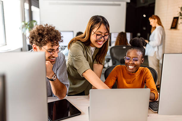 istock Multiethnic group of young colleagues working in modern office 2233592401