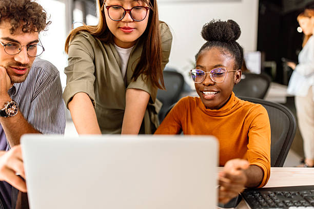 istock Multiethnic group of young colleagues working in modern office 2233592405
