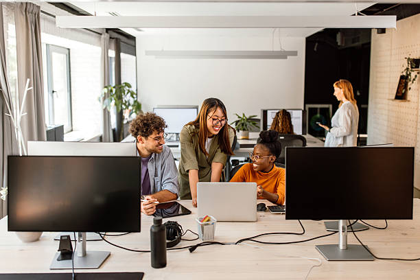 istock Multiethnic group of young colleagues working in modern office 2233592409