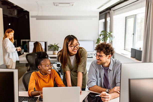 istock Multiethnic group of young colleagues working in modern office 2233592414