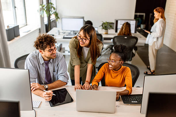 istock Multiethnic group of young colleagues working in modern office 2233592415