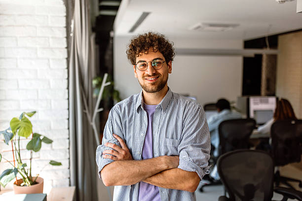 istock Young businessman posing for a photo in modern office 2233592442